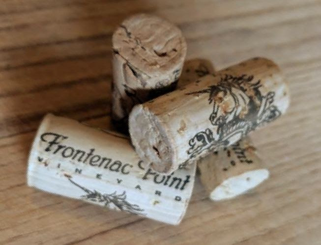 Four wine bottle corks with the Frontenac Point WInery logotype